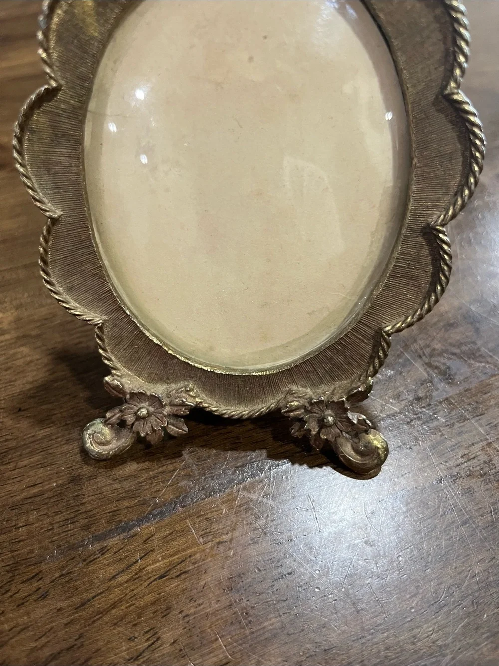Vintage gold plated oval frame with glass.